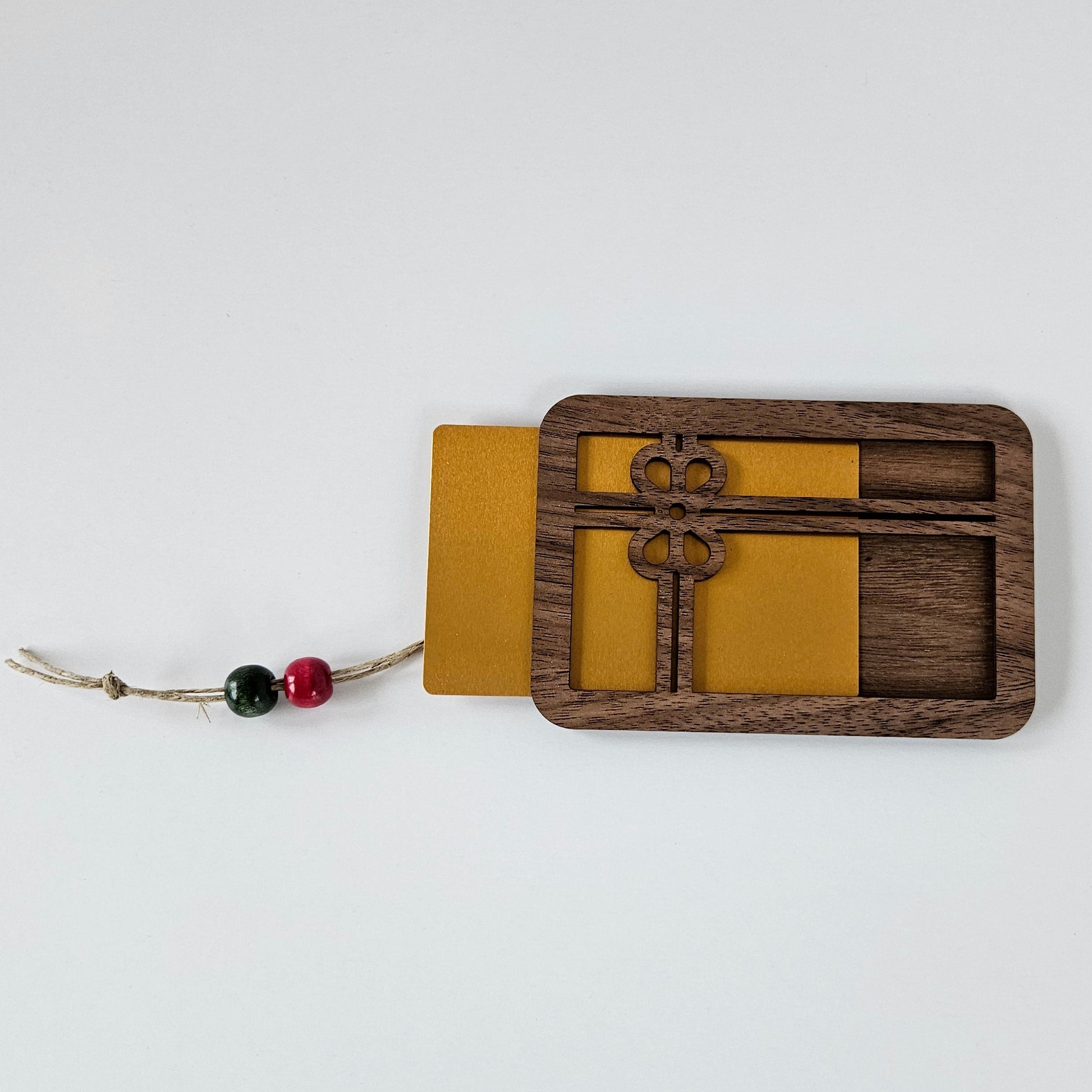 Wooden and metal gift card holder with decorative elements on a white background