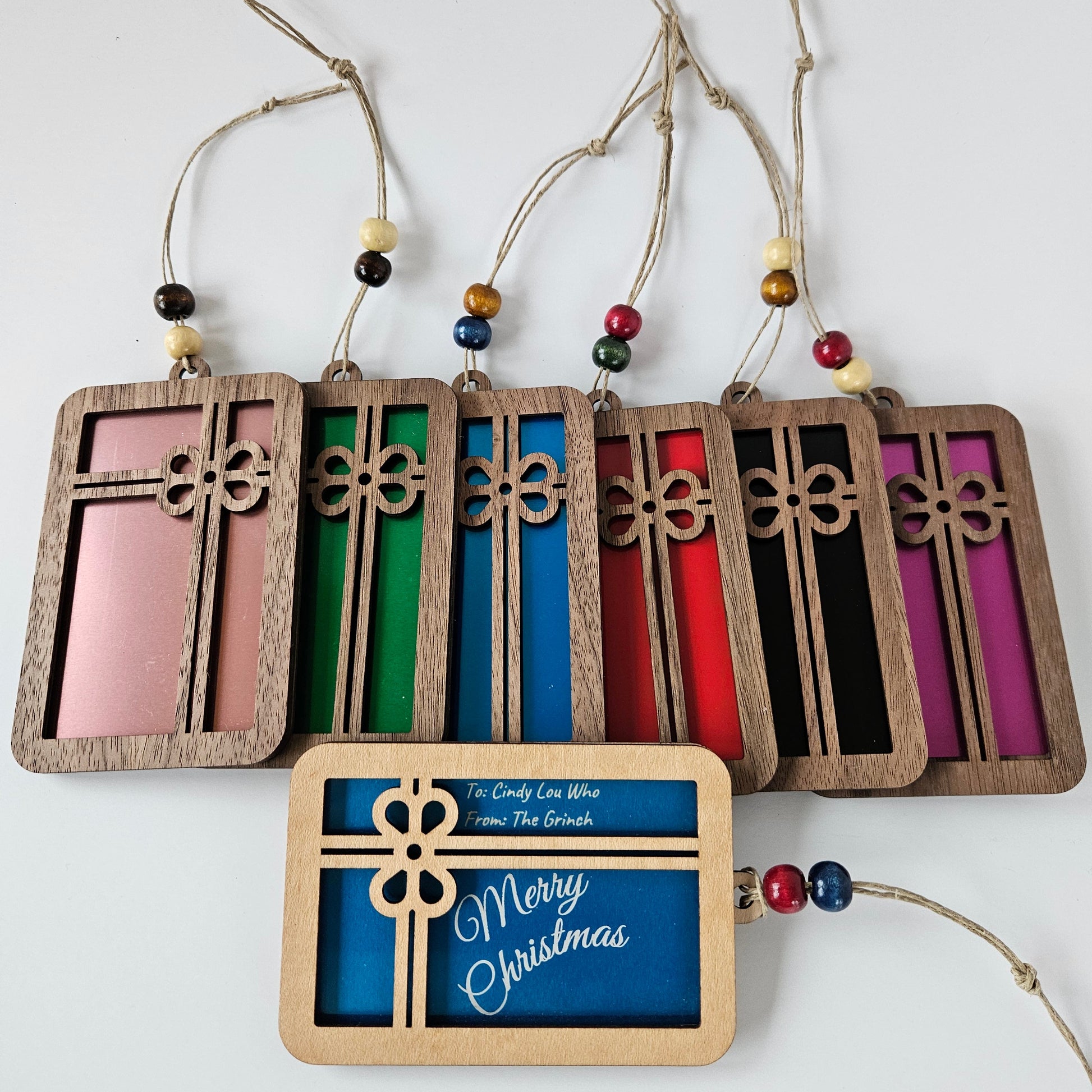 Set of colorful wooden Christmas tags with 'Merry Christmas' text on a white background