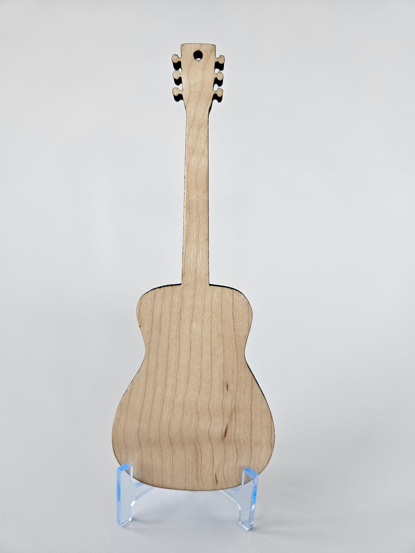 Back view of a wooden guitar on a white background